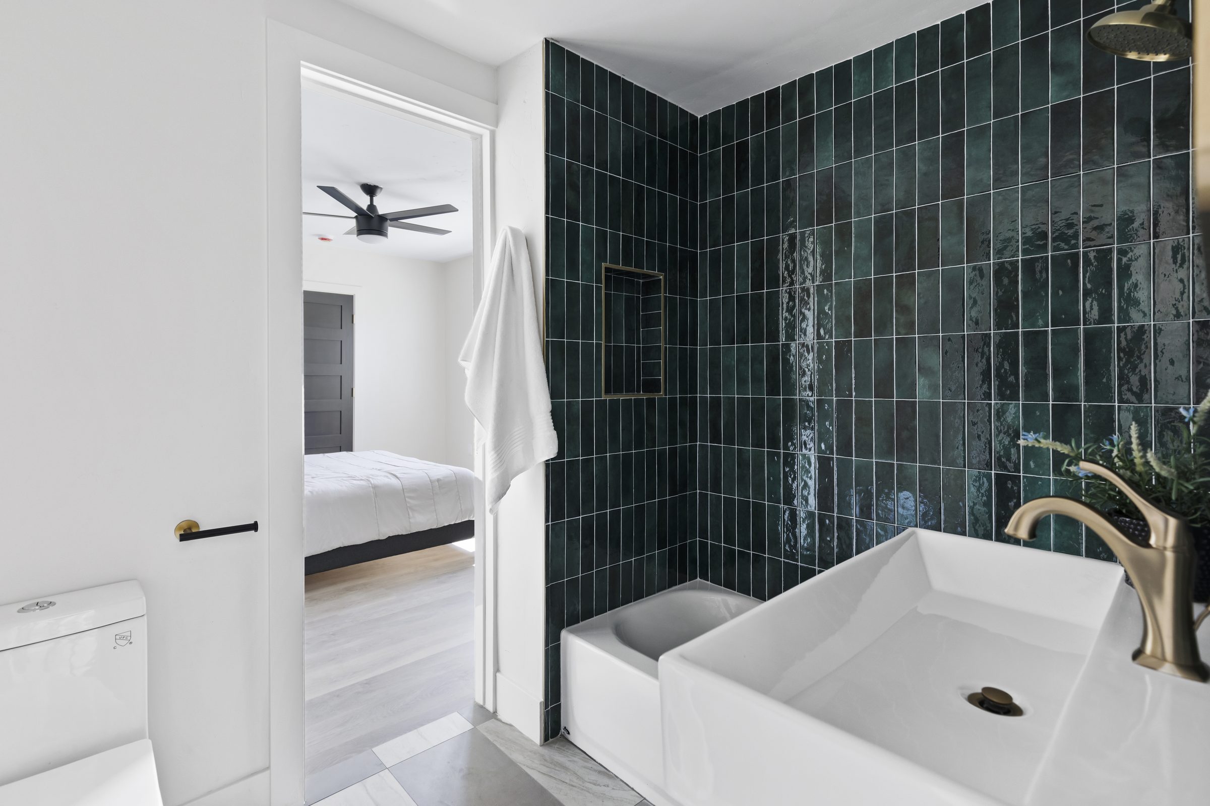 Finished bathroom — tiled walk-in shower and vanity detail